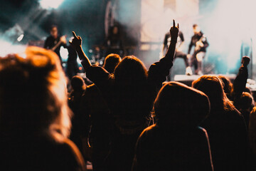 crowd at concert and silhouettes in stage lights