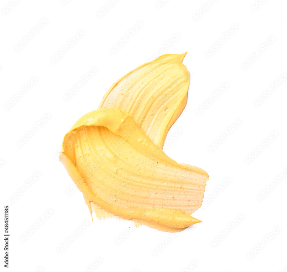 Smears of turmeric mask on white background