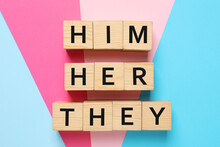 Gender Pronouns Him, Her And They Made Of Wooden Cubes On Color Background, Flat Lay