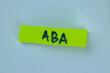 ABA write on sticky notes isolated on Wooden Table.