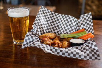 Wall Mural - glass of beer and chicken wings