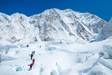 Fototapete - Group of climbers crossing Khumbu glacier crevasses reaching the Everest summit in Nepal. Team work concept.