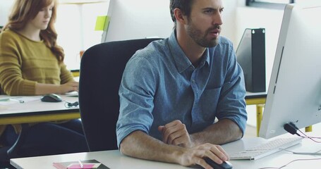Poster - Focused businessman typing on his computer doing research in the office. Young professional man using computer in the office to send emails. Serious young caucasian businessman working in office
