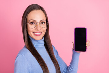 Canvas Print - Photo of confident cheerful lady demonstrate phone screen wear specs blue turtleneck isolated pink color background