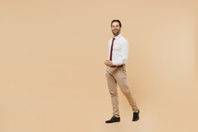 Full Body Side View Happy Young Successful Employee Business Man Corporate Lawyer 20s Wear White Shirt Red Tie Glasses Work In Office Walking Going Isolated On Plain Beige Background Studio Portrait.