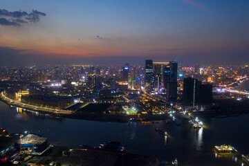 Wall Mural - Top View of Building in a City - Aerial view Skyscrapers flying by drone of Phnom Penh city with downtown , riverside and sunset