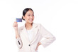 © ueaphan - Portrait of a happy young asian woman wearing suit holding bank card, credit card isolated on white background. Business online shopping concept.