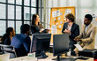 © Ann Rodchua - Diverse and multiracial smart businesspeople wearing formal suits, using computer, discussing, meeting, brainstorming together about company marketing plan or creative idea in indoor modern office.