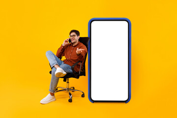 Poster - Businessman Near Big Smartphone Screen Talking On Cellphone, Yellow Background