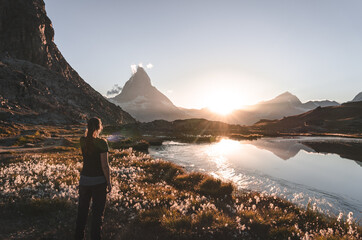 Fototapete - Woman enjoying the view at the famous Matterhorn from the Riffelsee.