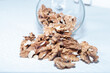Walnut seeds in a glass jar on a white background.
