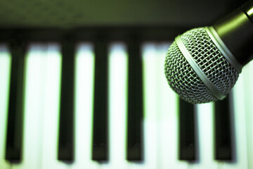 Wall Mural - Microphone over piano keys in dim light