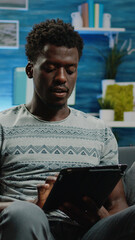 Poster - Adult holding digital tablet and typing on touch screen for online remote work. Business man using modern device working from home for corporate project. Entrepreneur with technology