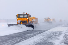 Snow Plow On The Runway In A Snowstorm