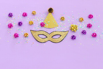 Wall Mural - Holidays image of mardi gras masquarade sequins mask over purple background. view from above