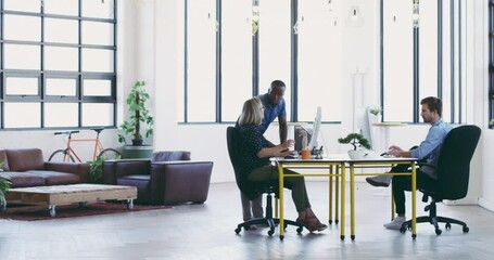 Poster - They work seamlessly together. African american business man talking to mature business woman at her desk, discussing work and looking at computer. Diverse group of three in modern office