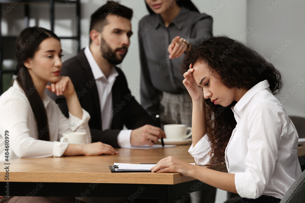 African American woman suffering from racial discrimination at work ...