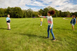 © Syda Productions - childhood, leisure and people concept - group of happy children playing game with flying disc at park