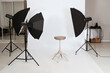 © New Africa - Empty stool surrounded by professional lighting equipment in photo studio