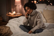 © Syda Productions - people, bedtime and communication concept - sad woman calling on smartphone sitting in bed at home