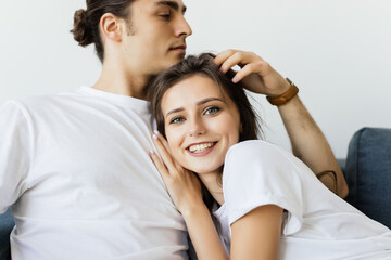  Close up of a charming young couple posing in their living room