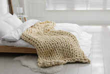 Soft Chunky Knit Blanket On Bed In Stylish Room Interior