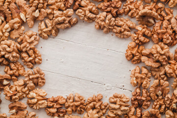 Wall Mural - Fresh walnuts on a white woden background. Copy space.