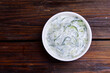 Tzatziki in a bowl. Tsatsiki top view. Traditional Greek dipping sauce or sauce tzatziki prepared with grated cucumber sour cream yogurt olive oil and fresh dill