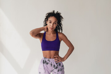 attractive black african american woman in stylish hipster fitness outfit on isolated background