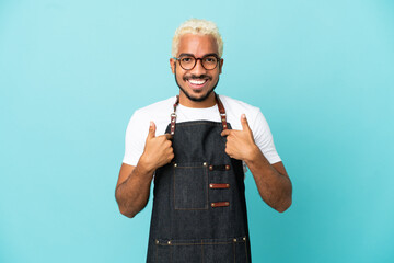 Poster - Restaurant Colombian waiter man isolated on blue background with surprise facial expression