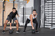 © LIGHTFIELD STUDIOS - Multiethnic sportsmen training with kettlebells in gym.