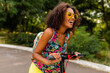 © mary_markevich - young stylish black woman having fun in park riding on electric kick scooter