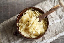 Fermented Cabbage Or Sauerkraut In A Pot With A Spoon