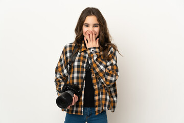 Wall Mural - Little photographer girl isolated on background happy and smiling covering mouth with hand