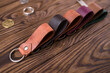 Leather key rings on wooden background