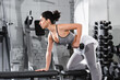 © LIGHTFIELD STUDIOS - Side view of middle east sportswoman training with dumbbells on flat bench in gym.