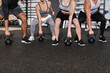 © LIGHTFIELD STUDIOS - Cropped view of friends working out with kettlebells in sports center.