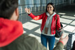 © NFstock - Overjoyed woman stretching hands to her husband while meeting him at the airport lounge after flying. Traveling and journeys concept