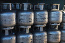 Close-up Of Silvery Gas Cylinders Stand On Top Of Each Other In Even Rows In A Warehouse