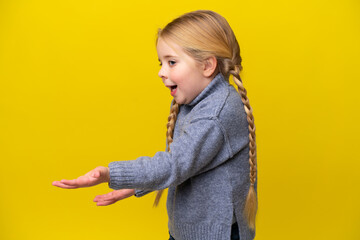 Wall Mural - Little caucasian girl isolated on yellow background with surprise facial expression