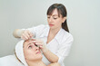 © elenavolf - Injection at spa salon. Doctor hands in gloves. Closeup. Pretty female patient. Beauty treatment. Healthy skin procedure. Young women face. Plasmolifting rejuvenation