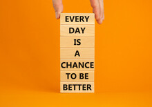 Chance To Be Better Symbol. Wooden Blocks With Words Every Day Is A Chance To Be Better. Beautiful Orange Background, Copy Space. Businessman Hand. Business, Motivational Chance To Be Better Concept.