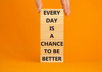 Wall Mural - Chance to be better symbol. Wooden blocks with words Every day is a chance to be better. Beautiful orange background, copy space. Businessman hand. Business, motivational chance to be better concept.