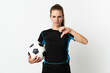 © luismolinero - Young football player woman isolated on white background showing thumb down with negative expression