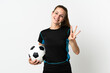 © luismolinero - Young football player woman isolated on white background happy and counting three with fingers