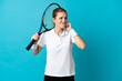 © luismolinero - Young woman tennis player isolated on blue background frustrated and covering ears