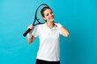 © luismolinero - Young woman tennis player isolated on blue background laughing