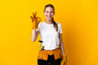 © luismolinero - Young electrician woman isolated on yellow background showing ok sign with fingers