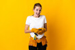 © luismolinero - Young electrician woman isolated on yellow background surprised and sending a message