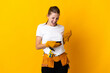 © luismolinero - Young electrician woman isolated on yellow background with phone in victory position